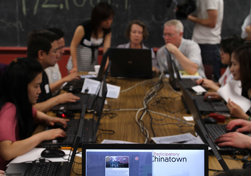 A number of people at laptop computers playing the Participatory Chinatown game