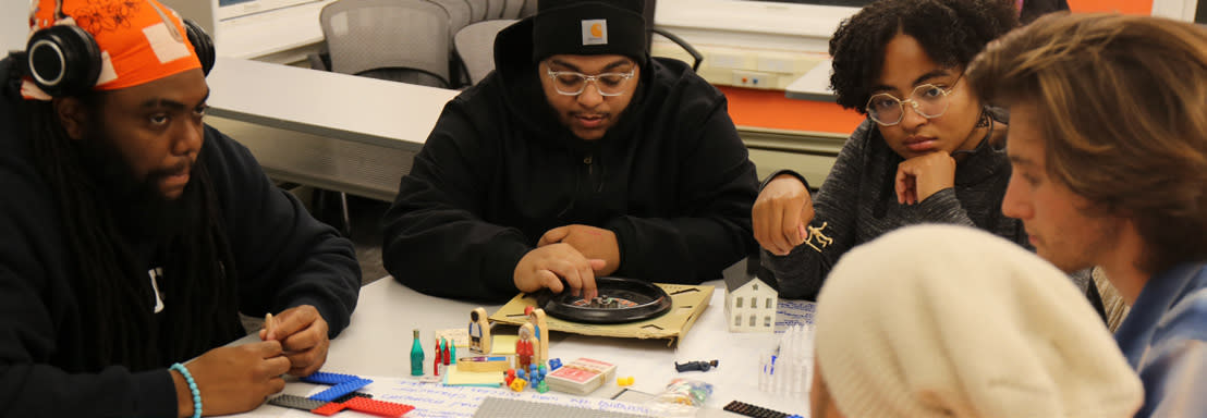 Learning partners gathered around a table with brainstorming materials