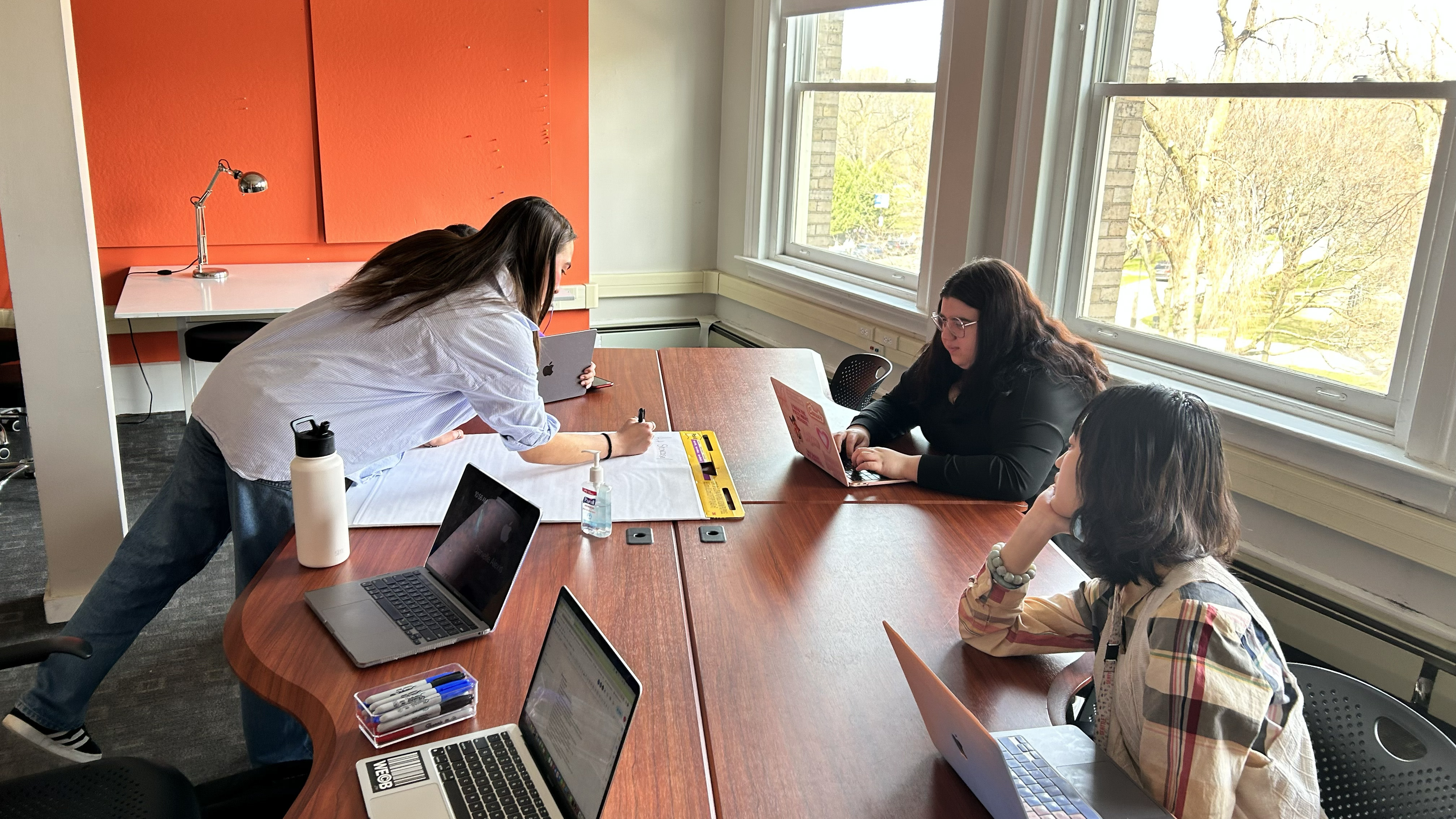 Students gathered around a table brainstorming