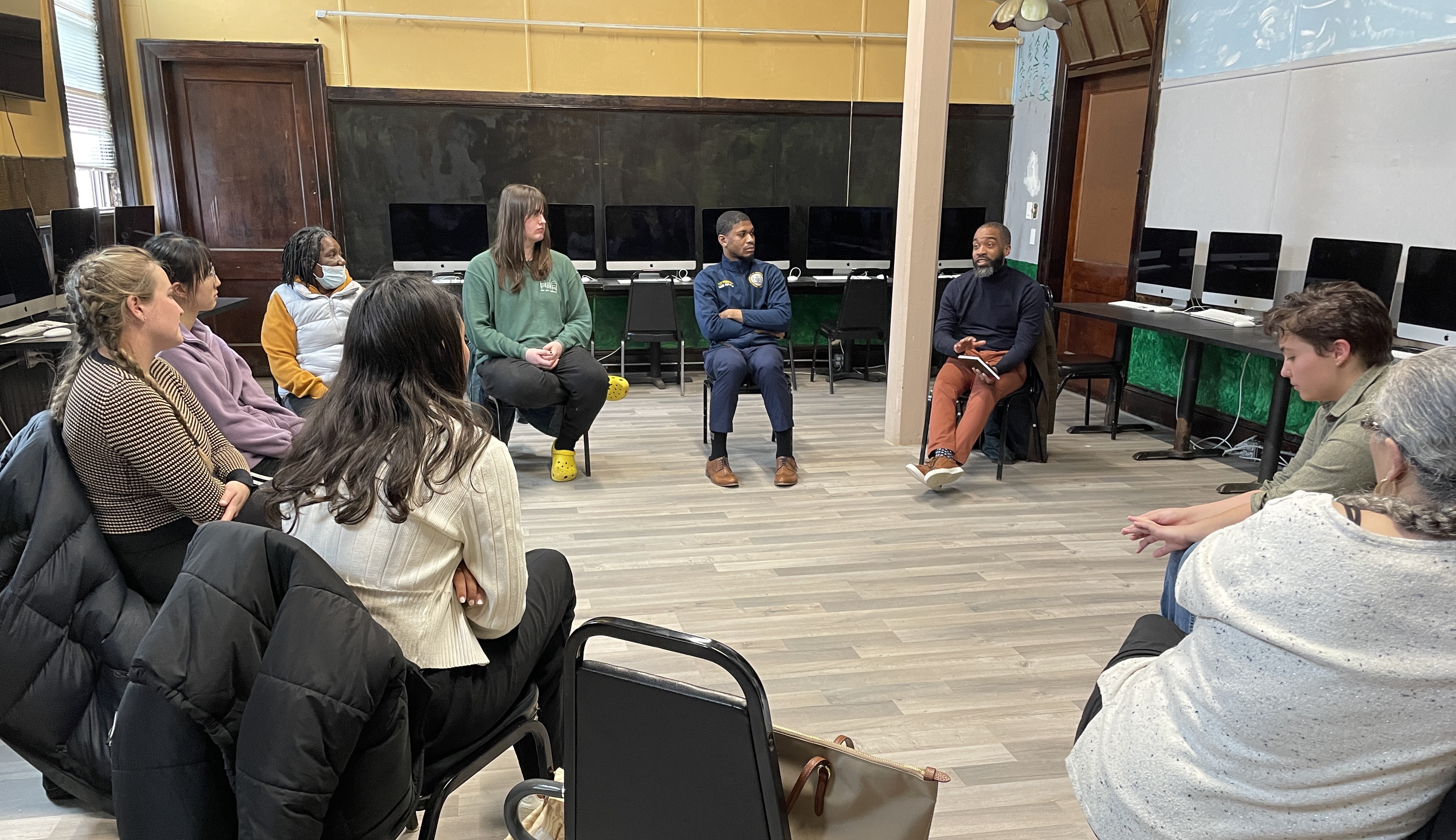 A group of Social Impact Studio participants seated in a circle