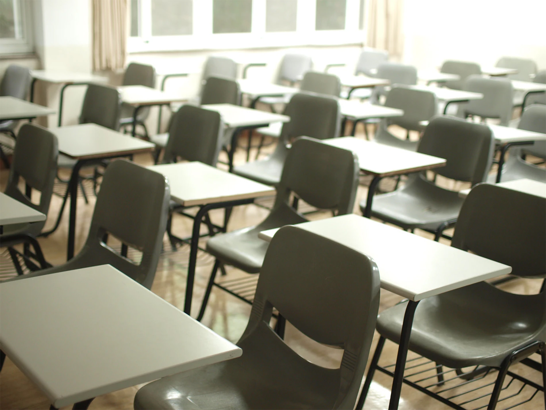 Rows of student desks in a classroom.