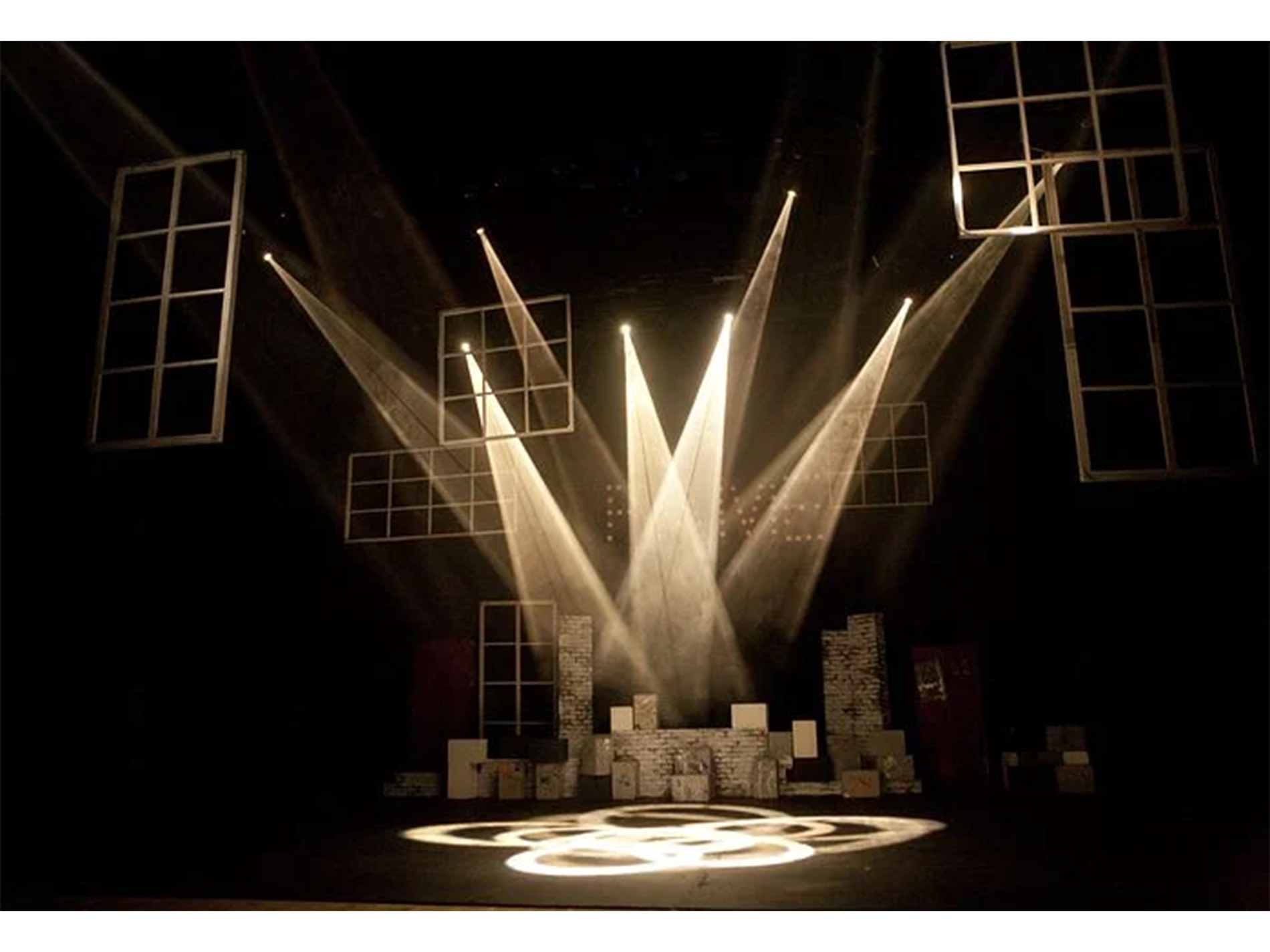 Lighting on a stage form circular shapes on the ground.