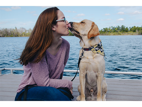 Photo of Destiny Murray with her dog, a Labrador/Golden retriever mix.