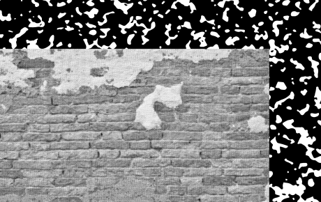 A grayscale photo of a brick wall over a black and white texture