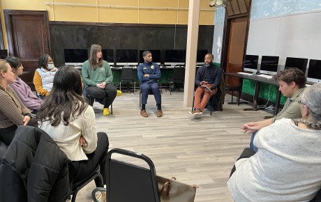 A group of Social Impact Studio participants seated in a circle