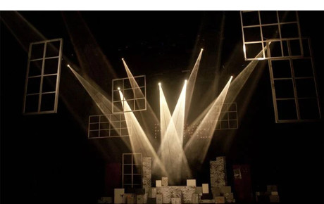 Lighting on a stage form circular shapes on the ground.