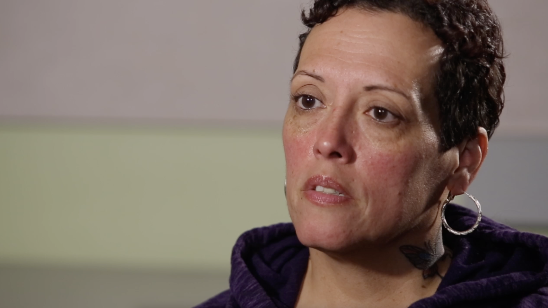 A woman with short cropped hair being interviewed