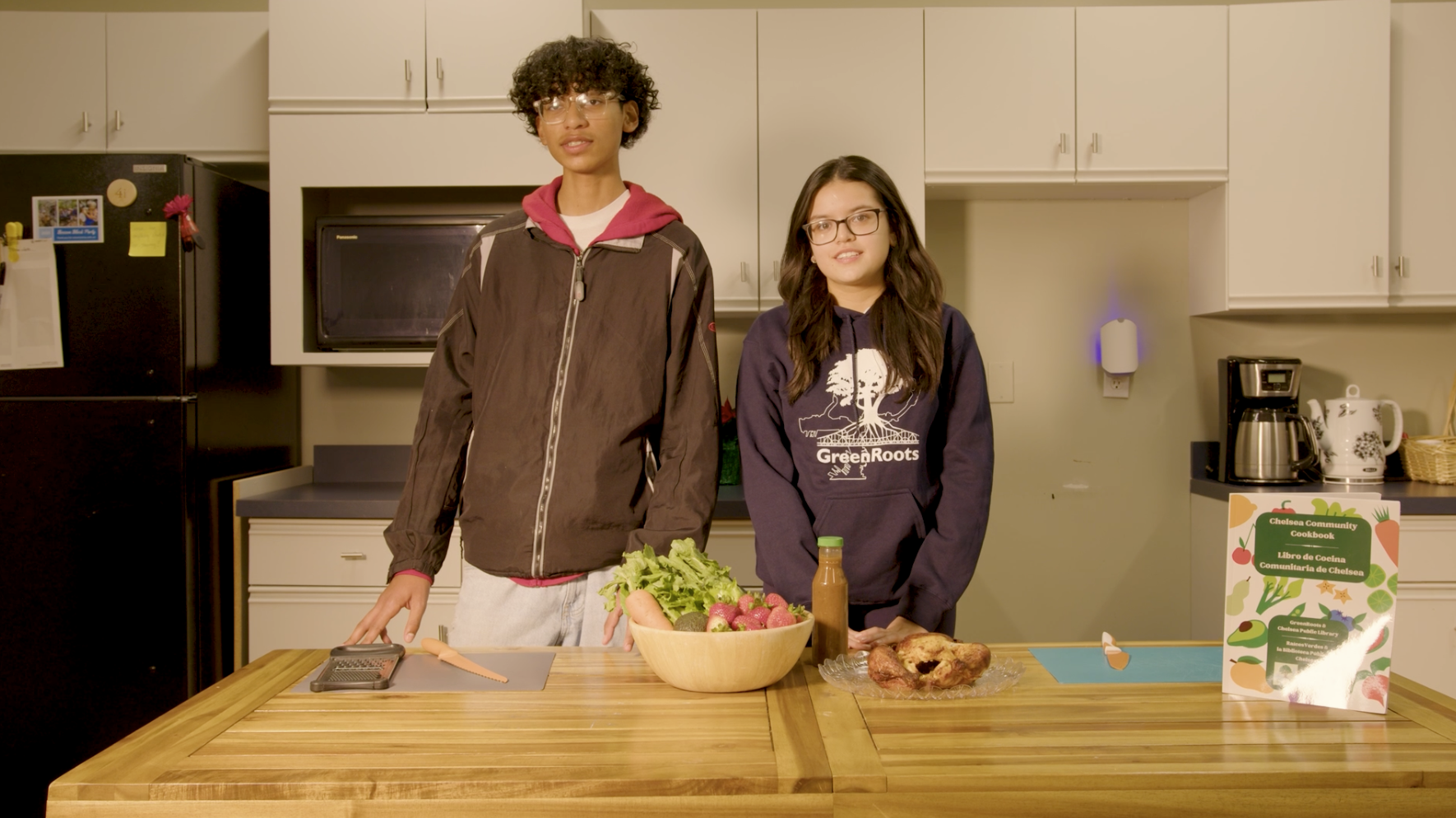 Teenagers standing with food prep in front of them on a kitchen counter