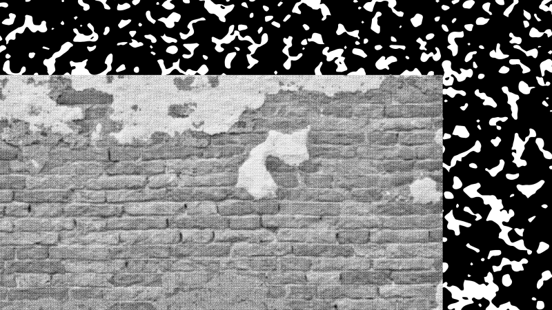 A grayscale photo of a brick wall over a black and white texture