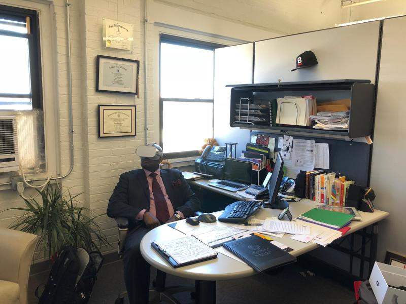 Photo of Kevin Sibley, former Director of the City of Boston‘s Mayor’s Office of Returning Citizens, watching a video.