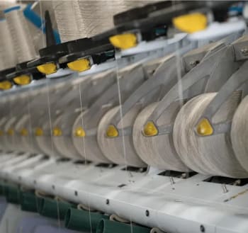 Thread and fiber spools being wound into PureColor carpet