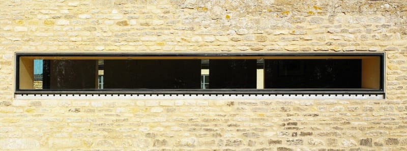 11023757-Narrow-horizontal-window-slit-in-stone-facade_iwh7vj.jpg
