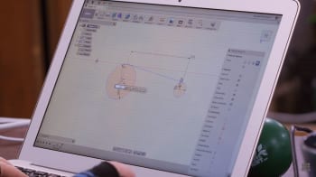 Corbeill designs a flipper for the pinball machine kit using Fusion 360. The team specializes in pinball machines and can easily jump right into designing on CAD. This isn’t always the case. Sometimes a crude prototype can help save time finding issues and homing in on the right CAD design. (Image courtesy of The Ben Heck Show.)