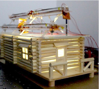 LEDs are powered inside a model home that has a hybrid solar and wind energy generator on the roof. (Image courtesy of the American Chemical Society.)