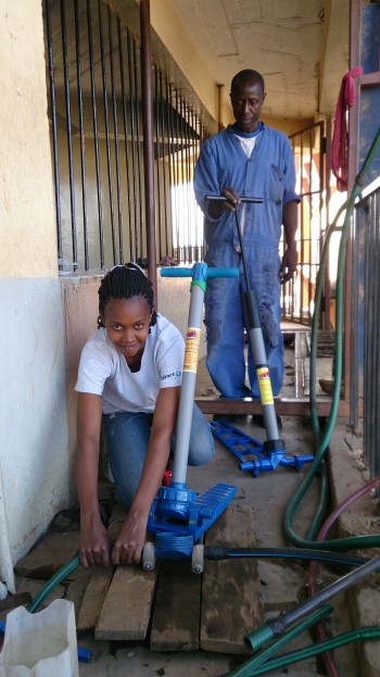 Winfred Maingi prepares to test a Starter Pump while Dalmas Otieno stands by with a larger MoneyMaker Hip Pump. Both are from KickStart International. (Image courtesy of KickStart International.)