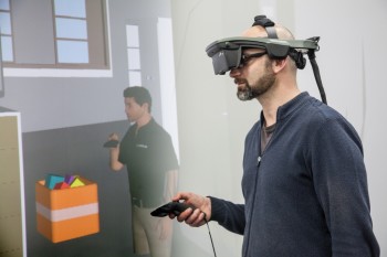 The VR suite uses HMD visors to immerse students in the subject matter. These visors enable students to control interactive avatars. (Image courtesy of Virtalis.)
