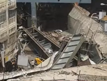 A scene of destruction in Kolkata: the Vivekananda Flyover collapse dropped 164 yards of steel and concrete onto a busy street. (Image courtesy of ABP News/YouTube.)