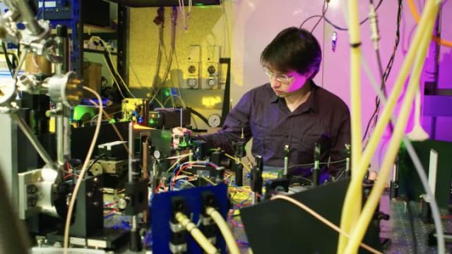 Milos Rančić with the experimental setup used to investigate materials for a telecom-compatible quantum memory. (Image courtesy of Stuart Hay, ANU.)