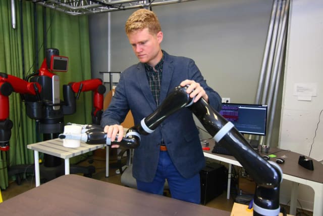 Rice University researchers led by graduate student Dylan Losey want to help humans and robots collaborate by enabling interactive tasks like rehabilitation, surgery and training programs in which environments are less predictable. In early studies, Losey and colleagues at the University of California, Berkeley, used gentle feedback to train a robot arm to manipulate a coffee cup in real time. (Image courtesy Andrea Bajcsy)