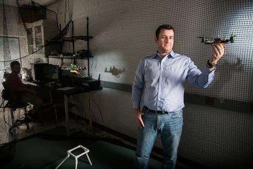 Panagiotis Artemiadis, professor of mechanical and aerospace engineering at Arizona State University, with two drones in his Human-Oriented Robotics and Control (HORC) Lab at the ASU Tempe campus. (Image courtesy of Deanna Dent/ASU Now.)