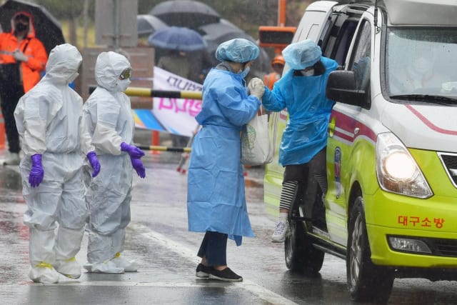 A COVID-19 patient arrives at a hospital in South Korea. (Image courtesy of Wang Jingqiang/Xinhua/Redux.)