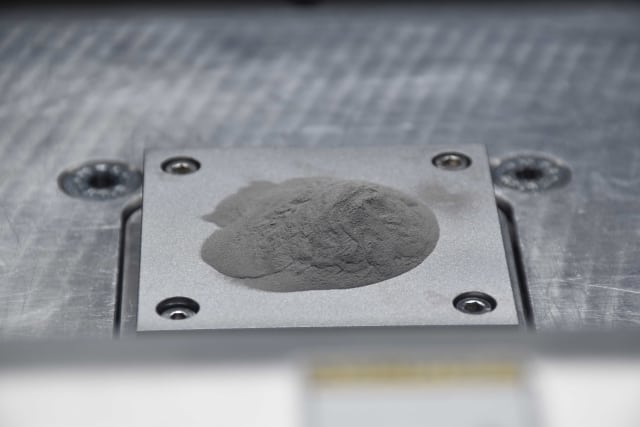 The nanoparticle-functionalized powder is fed into a 3-D printer, which layers the powder and laser-fuses each layer to construct a three-dimensional object. (Image courtesy of HRL Laboratories.)