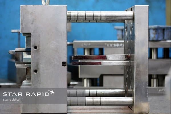 3D printed cores and inserts mounted onto the plastic injection molding base plates.