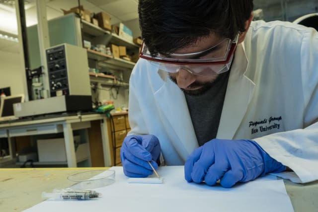 Rice University graduate student Amram Bengio sets up a nanotube fiber antenna for testing. Scientists at Rice and the National Institute of Standards and Technology have determined that nanotube fibers made at Rice can be as good as copper antennas but 20 times lighter. (Image courtesy of Jeff Fitlow/Rice University.)
