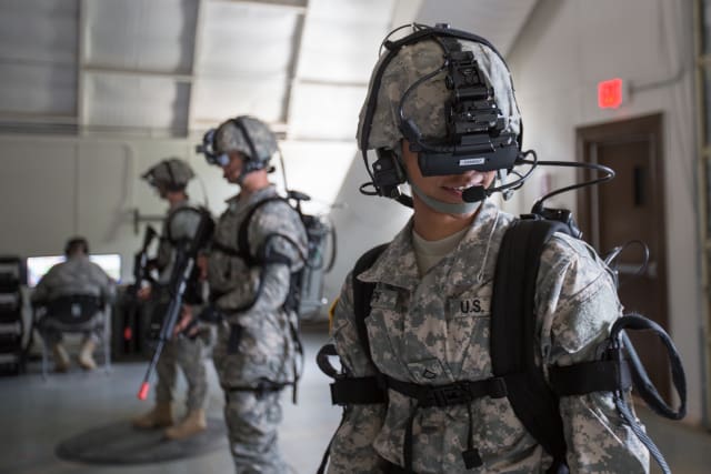 Pfc. Shante Sapp, assigned to Headquarters and Headquarters Company, 35th Engineer Brigade, Missouri National Guard, moves her head to see the landscape in a simulated virtual training environment using the Dismounted Soldier Training System at Fort Leonard Wood. The system uses motion tracking to allow soldiers to train in a simulated deployed environment. (U.S. Army photo by Pfc. Samantha J. Whitehead.)