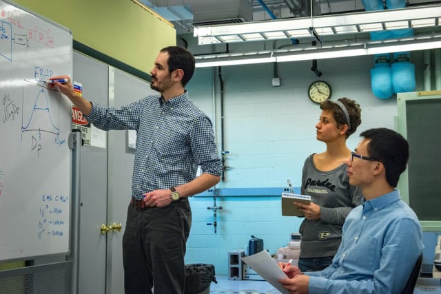 Brandon Boor, a Purdue University assistant professor of civil engineering and environmental and ecological engineering, together with graduate students Danielle Wagner and Tianren Wu, are studying air quality in indoor environments. Their most recent study focused on what babies breathe while crawling on carpets. (Image courtesy of Marshall Farthing.)