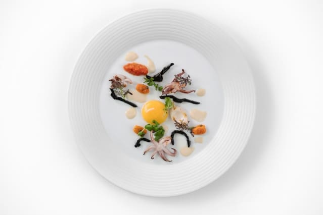 Helix noodle with Point Judith squid, confit egg yolk, and white hoisin, by Matthew Delisle. (Image courtesy of Michael Indresano Production.)