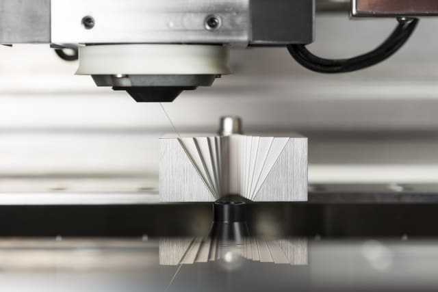 A close-up shot of a wire EDM cutting a delicate taper in a workpiece. (Image Source: GF Machining Solutions)