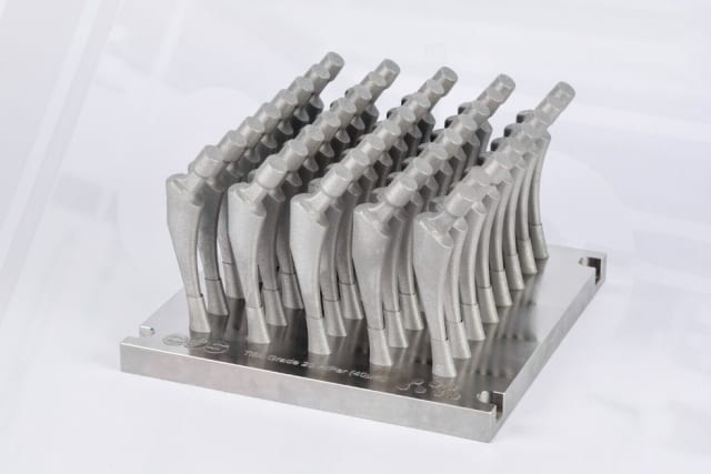 Orthopedic hip stem implants in a high-density build. Smart support design and build orientation means high volumetric efficiency and a support that “disappears” with post build machining. (Image courtesy of EOS.)