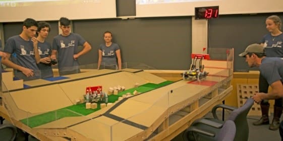 Team Walsh E holds their breath as they test their robot’s ability to collect and place the blocks for points. (Image courtesy of Alana Davitt/SEAS Communications.)