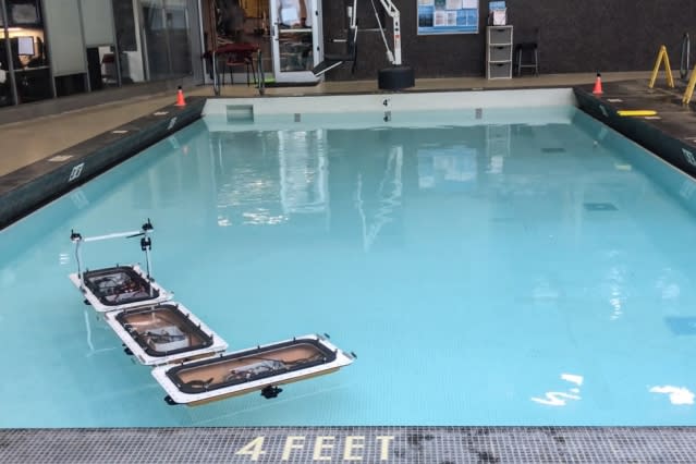 Roboats in an MIT pool use a novel latching mechanism to form an L-shape.