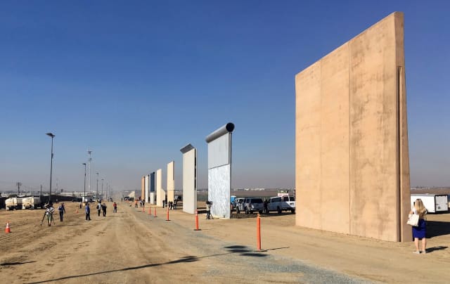 The border wall prototypes, immediately after their construction ended in 2018. A new government watchdog report suggests that the construction and decision process for the wall might be flawed. (Image courtesy of Elliott Spagat/AP.)