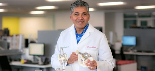 Head of Johnson & Johnson’s 3D Printing Center of Excellence, Sam Onukuri, holding a patient-specific, 3D-printed implant. (Image courtesy of Johnson & Johnson.)