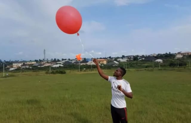 Kanda weather balloon being launched by a West African local. These balloons are capable of recording climate data, which will be transmitted and stored through the Telos blockchain. (Photo courtesy of Kanda.)