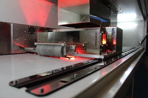 The High Speed Sintering printhead performing a print. (Image courtesy of Loughborough University.)