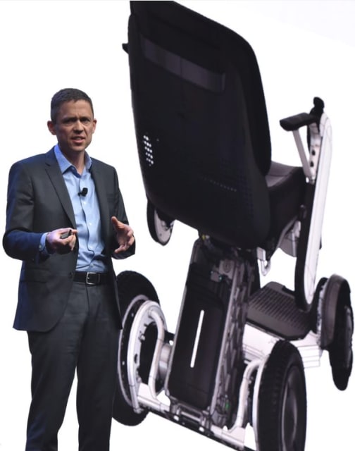 Stephen Hooper, VP and general manager of Fusion 360 products at Autodesk, shows a generative design part being used in production of the Whill wheelchair at Autodesk University 2018. (Picture courtesy of Autodesk.)
