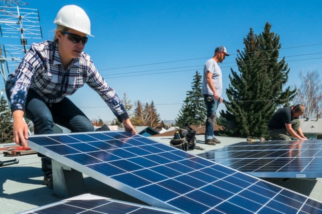 Installing solar panels. (Image courtesy of MIT.)
