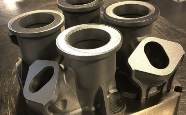 GE Aviation is saving time and money by 3D printing four bleed air adapter caps that were previously made with conventional castings. (Image courtesy of GE Aviation.)