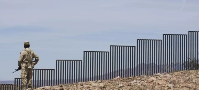 A CBP officer patrols the U.S.-Mexico border. Like this segment, much of the border lies on rocky or mountainous terrain. (AP Photo/Guillermo Arias.)