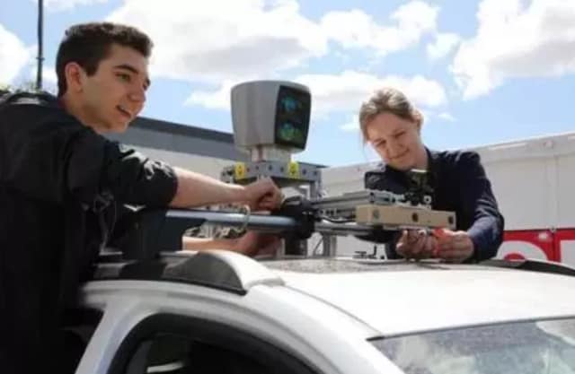 Robert Adragna, left, and a teammate from the University of Toronto participate in the AutoDrive Challenge. (Image courtesy of Velodyne LiDAR.)
