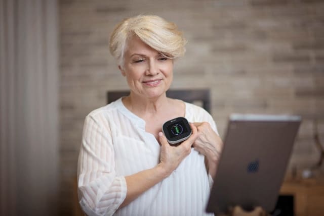 A senior patient uses the TytoHome kit to listen to the heart and interact with a caregiver over the Internet without leaving the house. (Image courtesy of TytoCare.)