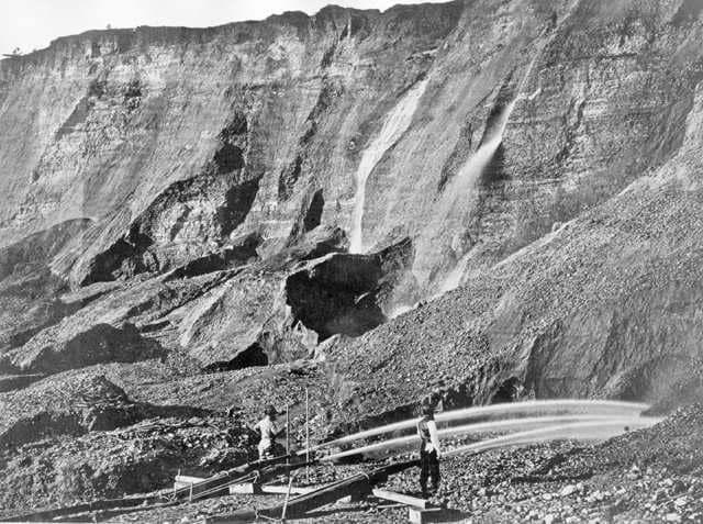Washing away a mountain at a placer mine in Dutch Flat, Calif. Hydraulic mining, first used by Romans, came back strong during the California Gold Rush. Water under high pressure eroded away entire hills so prospectors could check sluices for gold in the runoff. The effect on natural ecosystems was devastating. Billions of tons of earth clogged rivers and worsened floods. (Image courtesy of Wikipedia.)