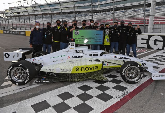 The PoliMOVE team, pictured with its AV, won first place in the Autonomous Challenge at CES 2022. (Image courtesy of Indy Autonomous Challenge.)