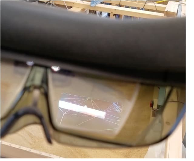 Through AR goggles, construction workers can view an image of a pipe buried beneath sand constructed from the cognitive GPR data. (Image from video courtesy of the University of Vermont and University of Tennessee at Chattanooga.)