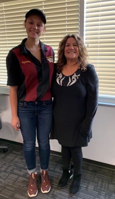 Brenda Discher, right, with Sydney Hardesty, senior at Davision High School and captain of the First Robotics Davision HOUSE OF CARDS Team #3534, which Siemens sponsors.