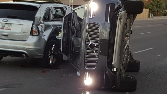 No moose in sight, but this 2017 battle of SUVs still resulted in a rollover. Uber’s Volvo went through an orange light at 38 mph, hitting a Honda CR-V and two other cars, before turning on its side. No one was killed. (Image courtesy of Fresco News.)